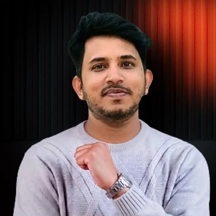 Smiling man in grey sweater with watch and clenched fist.